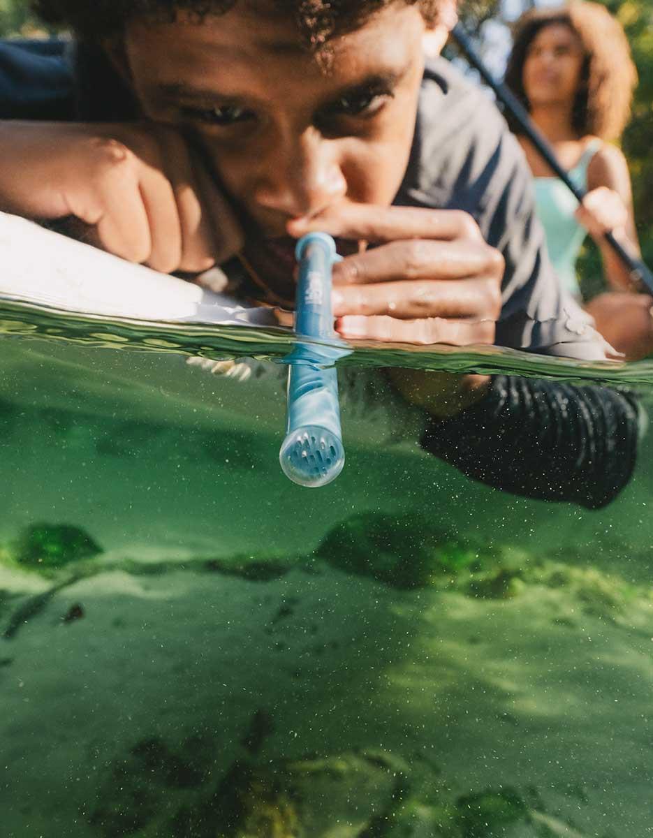 Child drinking through a LifeStraw Sip Essential straw