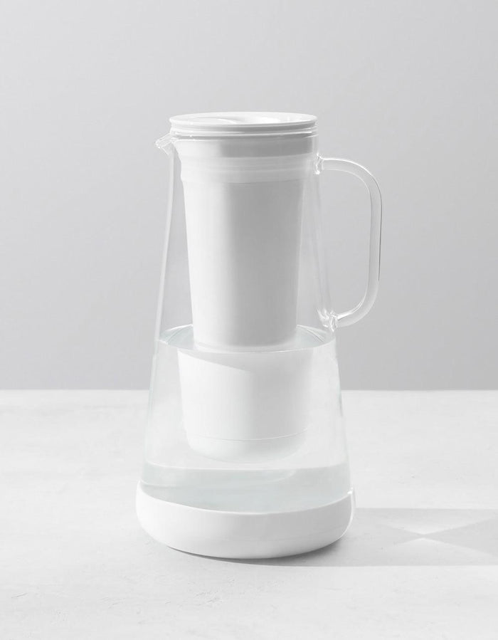 LifeStraw Home 7-Cup Glass water filter pitcher in White, filled with water